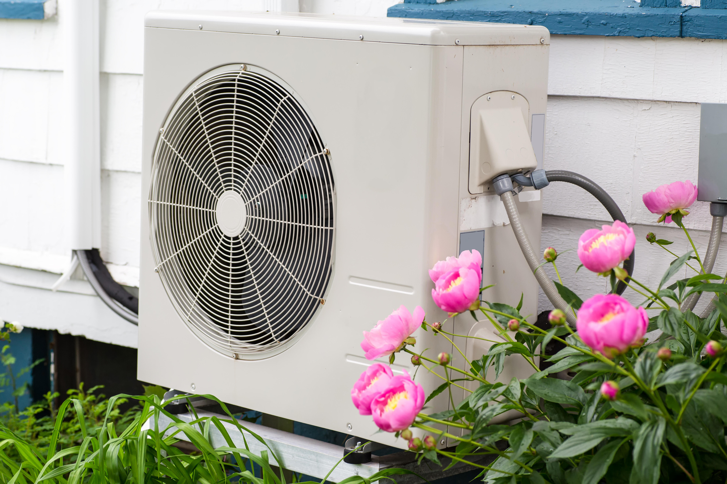 Air conditioning/heat pump unit on the side of a house