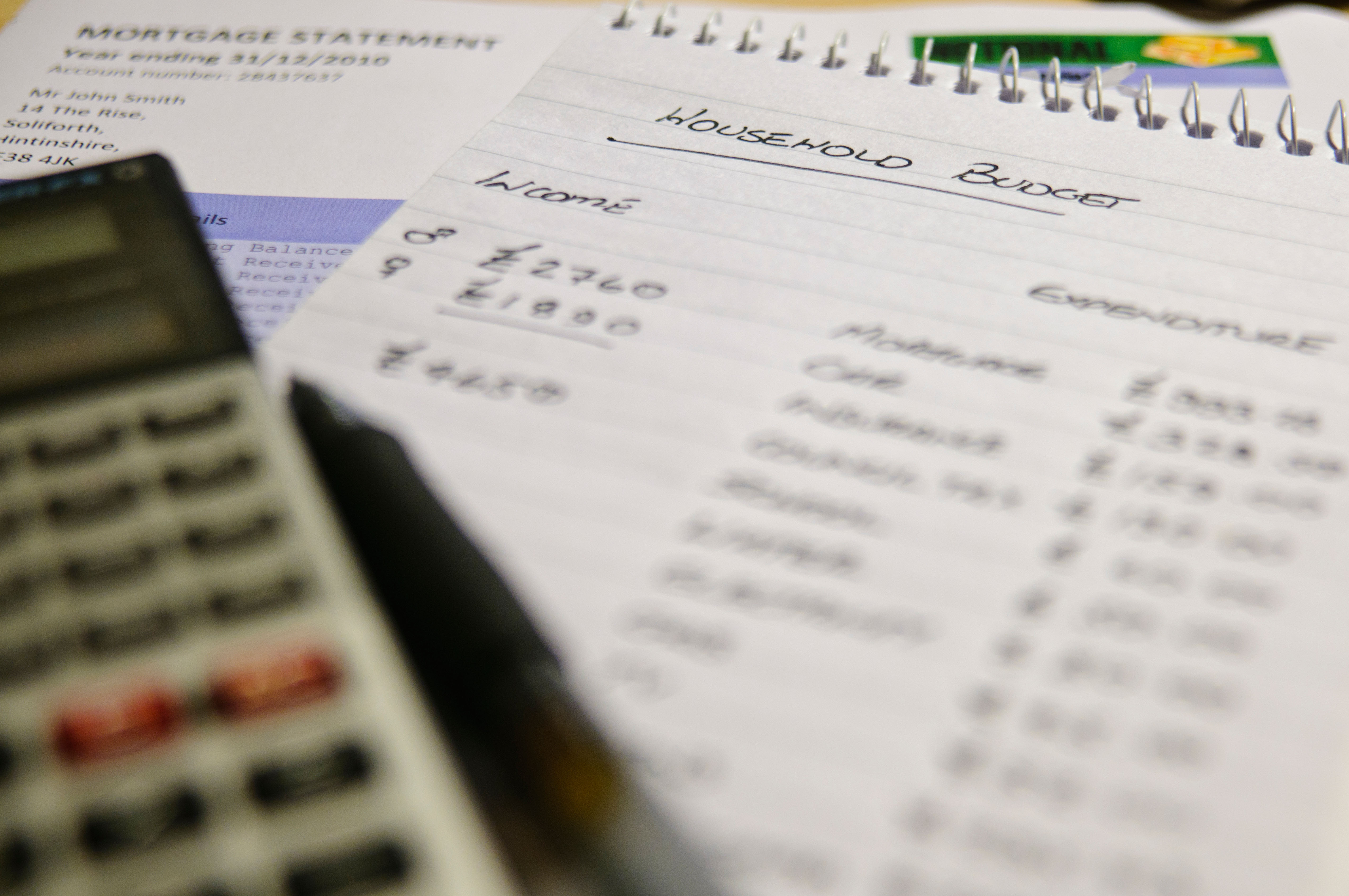 Household budget with a calculator and mortgage statement