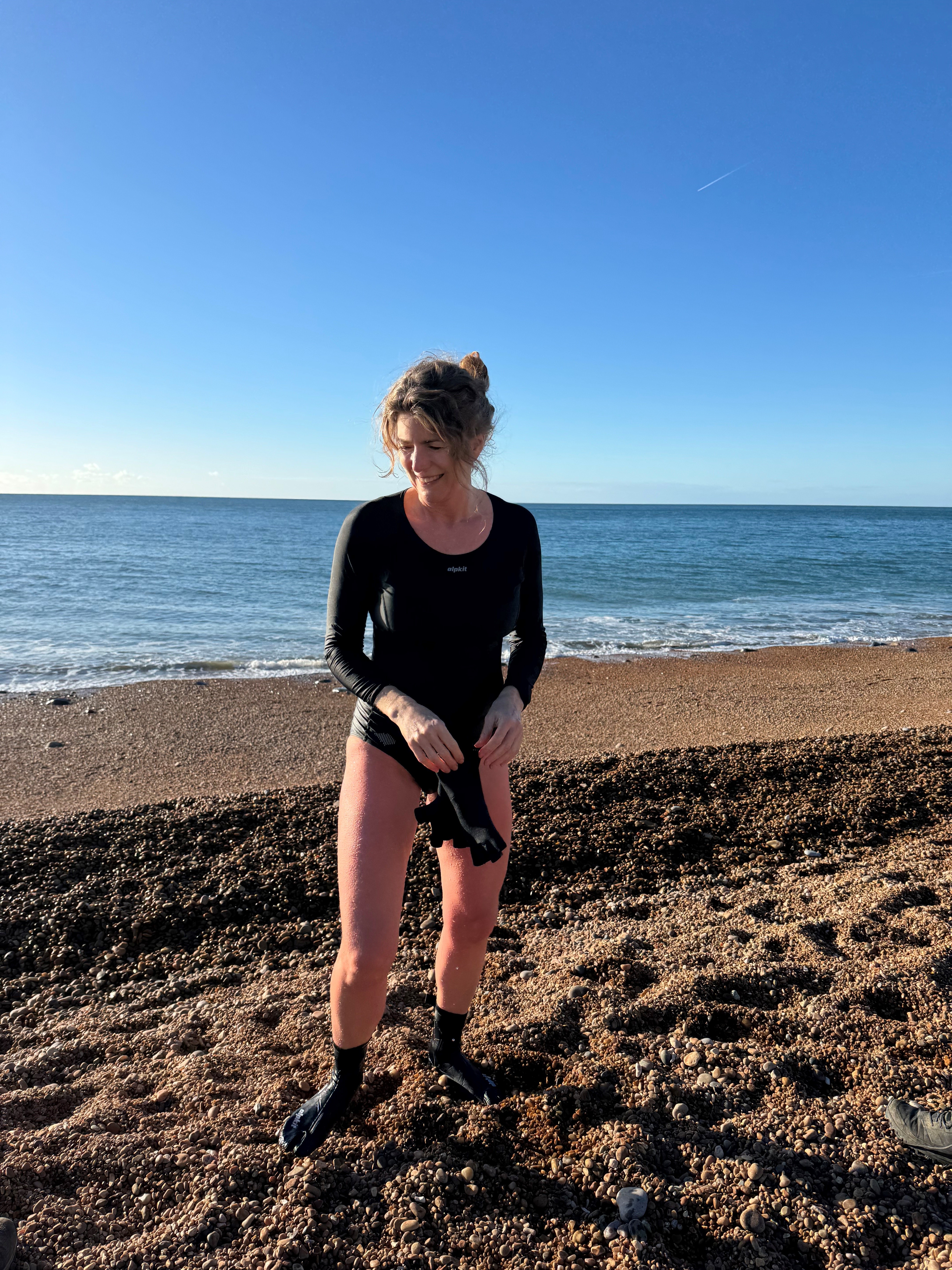 Kate Rew standing on Seatown beach in Dorset (Tim Bridges/PA)
