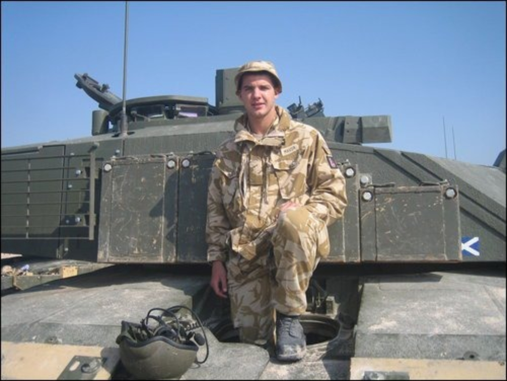 Danny Mavor in his Army uniform, on top of an armoured vehicle