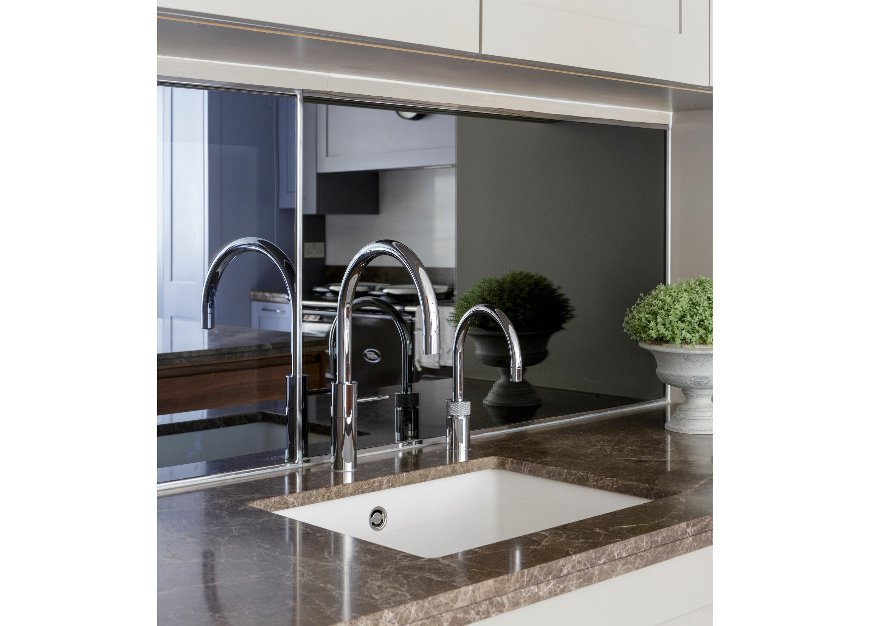 Modern kitchen with small butlers sink with mirrored splashback