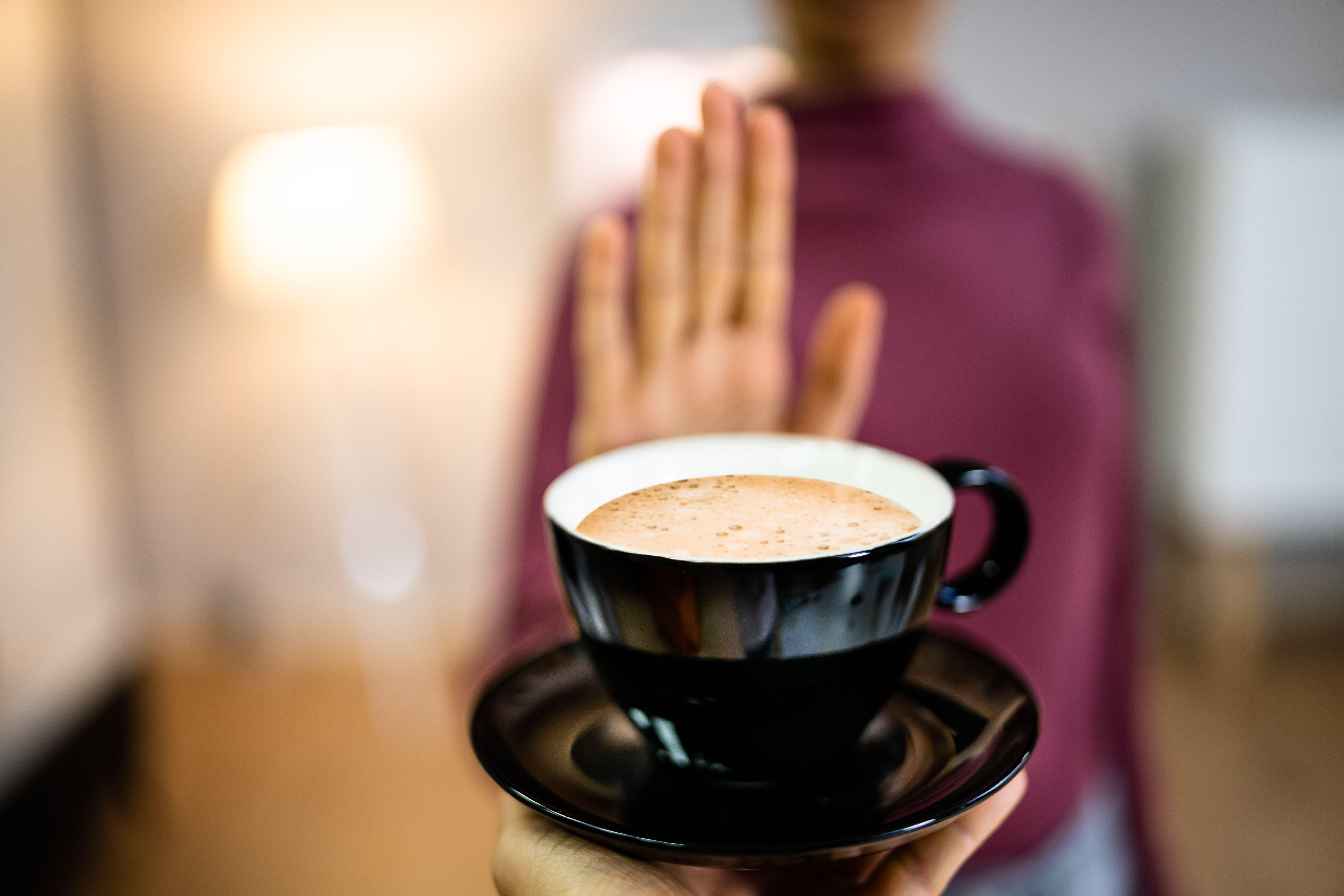 Mum holding out hand to refuse coffee