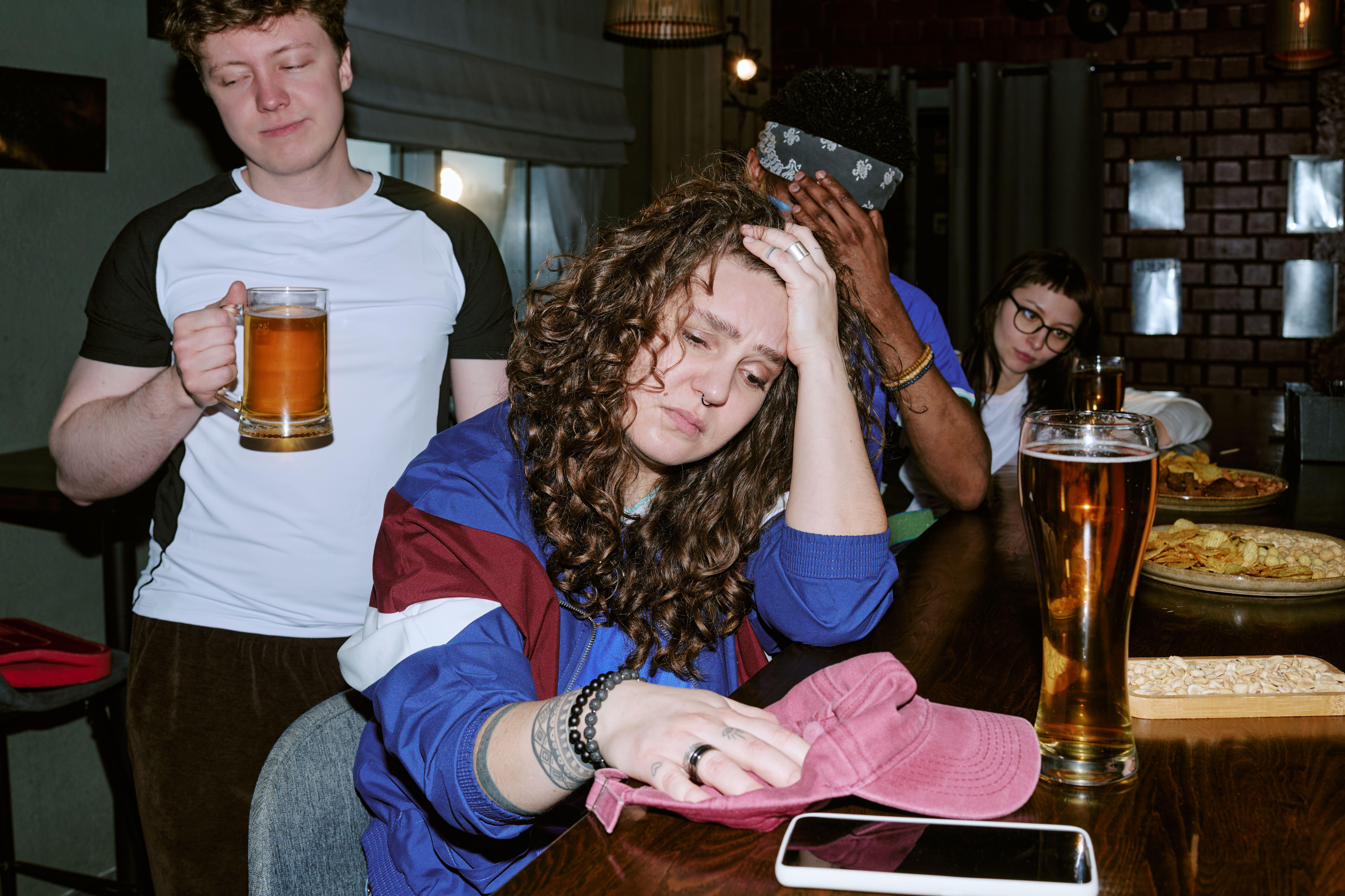 Adult woman looking sad at a bar 