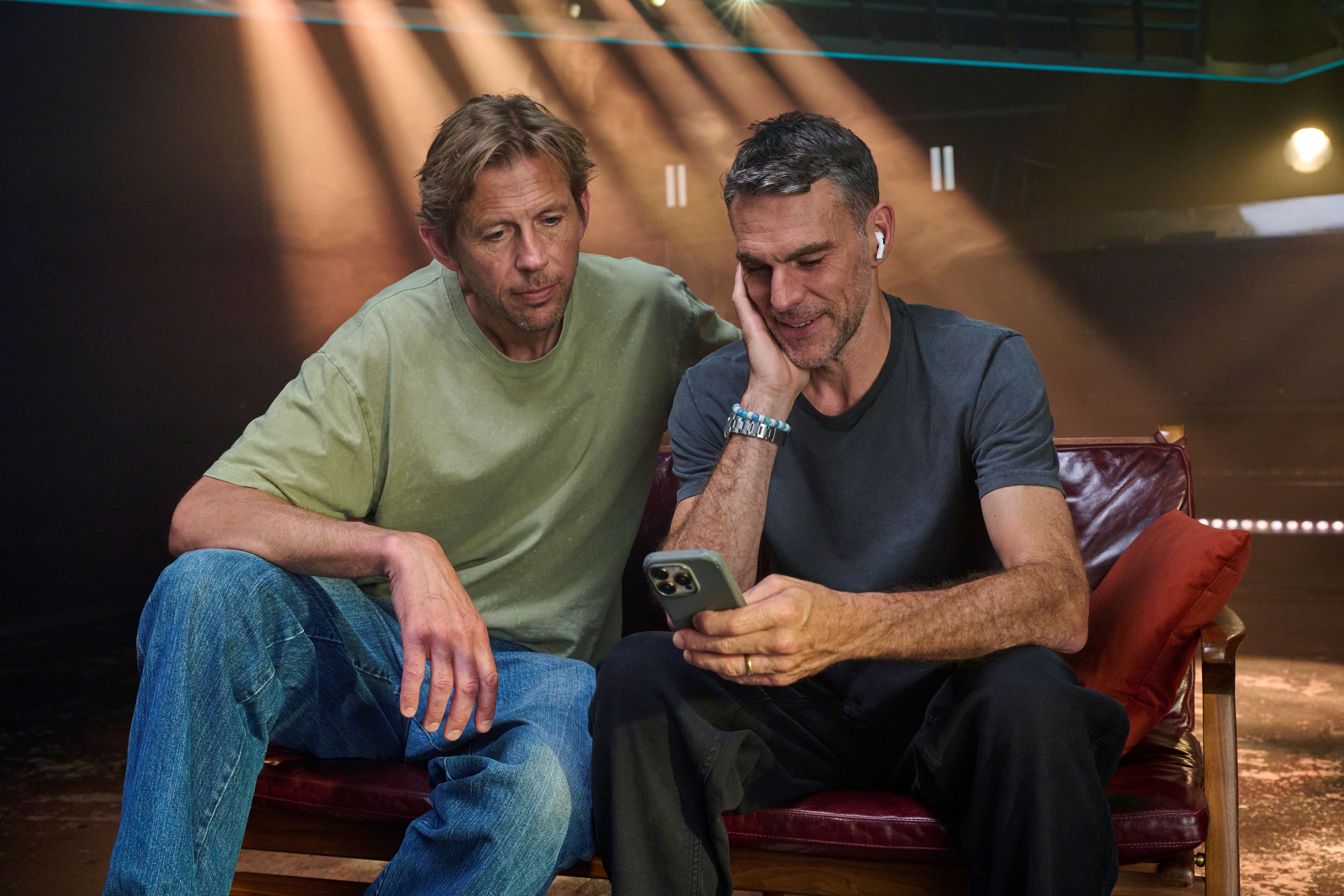 Groove Armada's Tom Findlay (r) and Andy Cato (l) looking at a phone (Stewart Williams/PA)