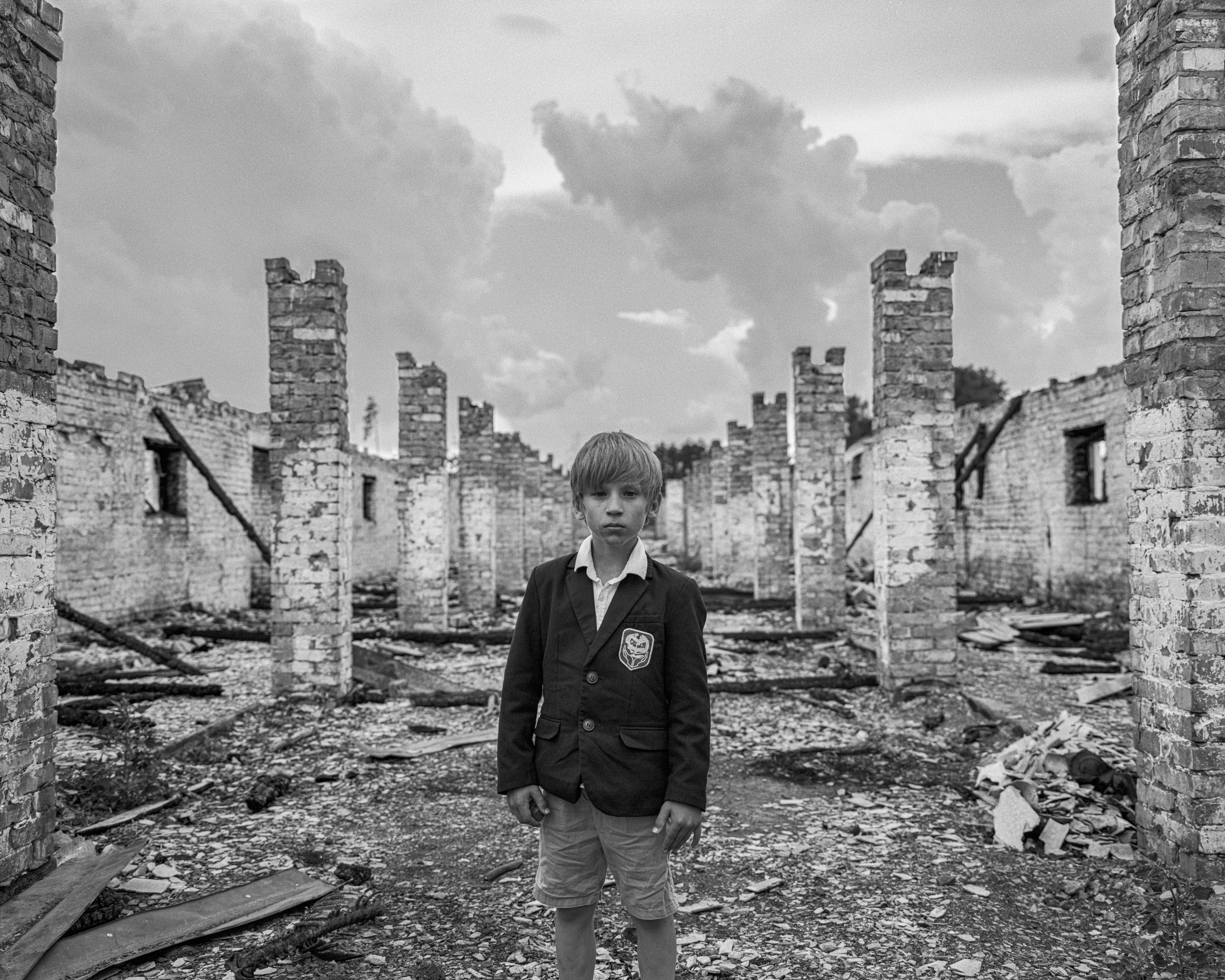‘Schoolboy, destroyed farm, Kyiv region’ October 2022’ by Mark Neville for the exhibition