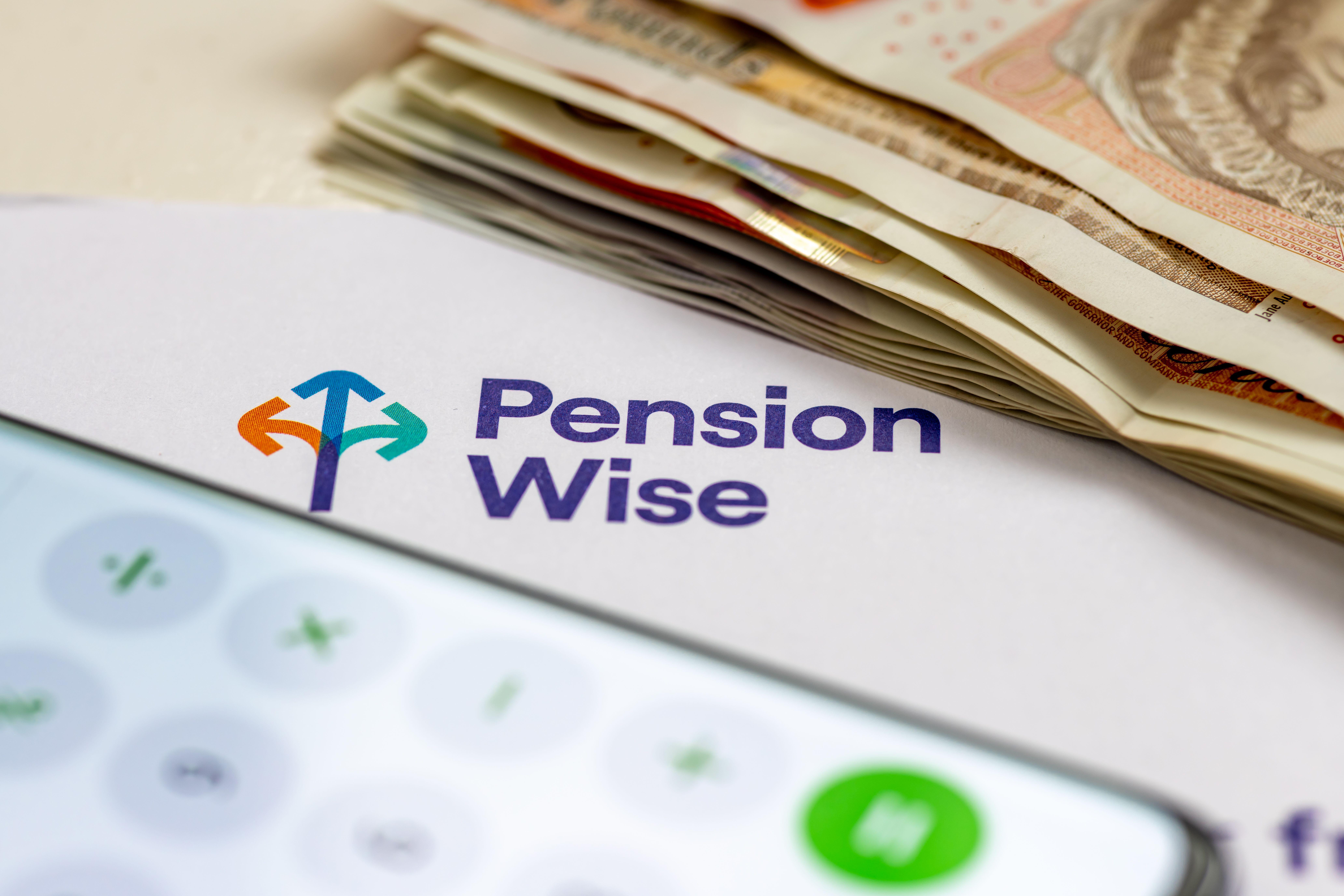 A stack of bank notes and a phone calculator on a letter from Pension Wise