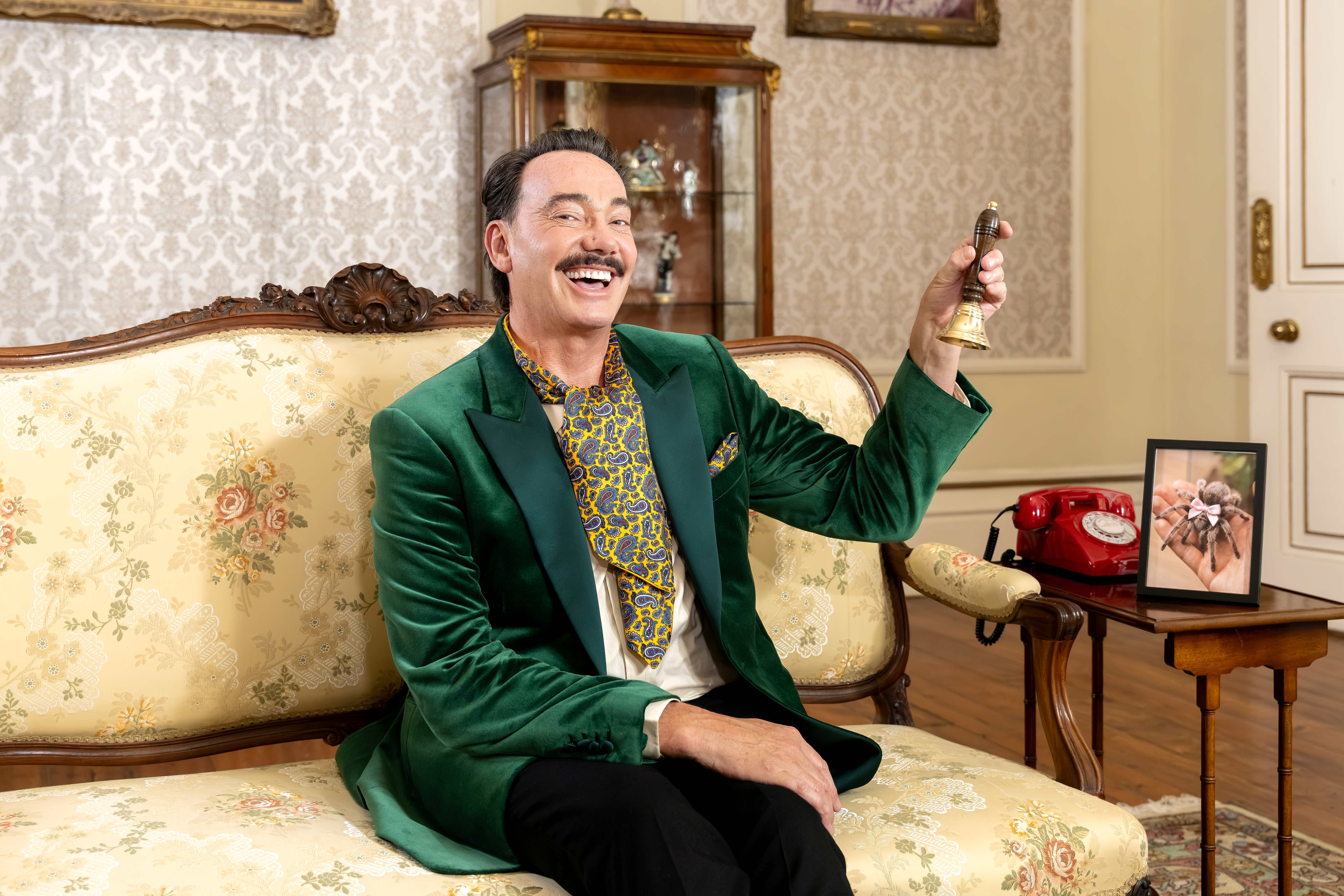 Craig Revel Horwood ringing a bell