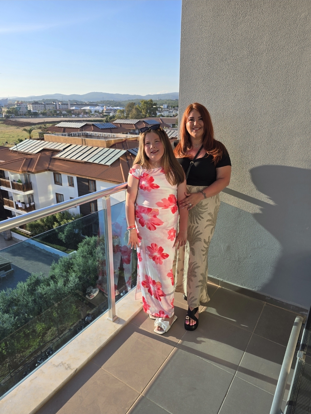 Alyssa and her mother on a balcony
