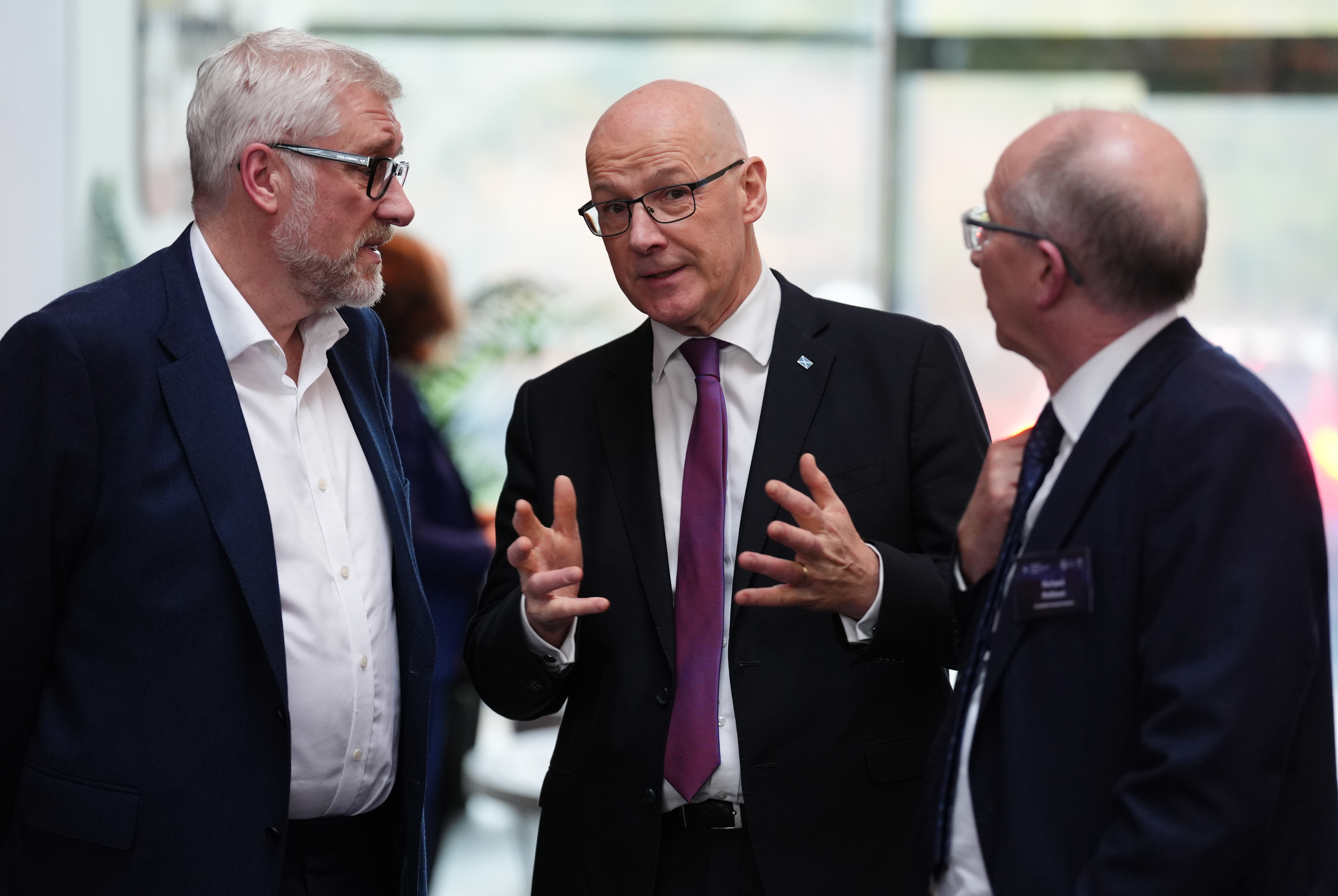Sandy Begbie standing with John Swinney and another man