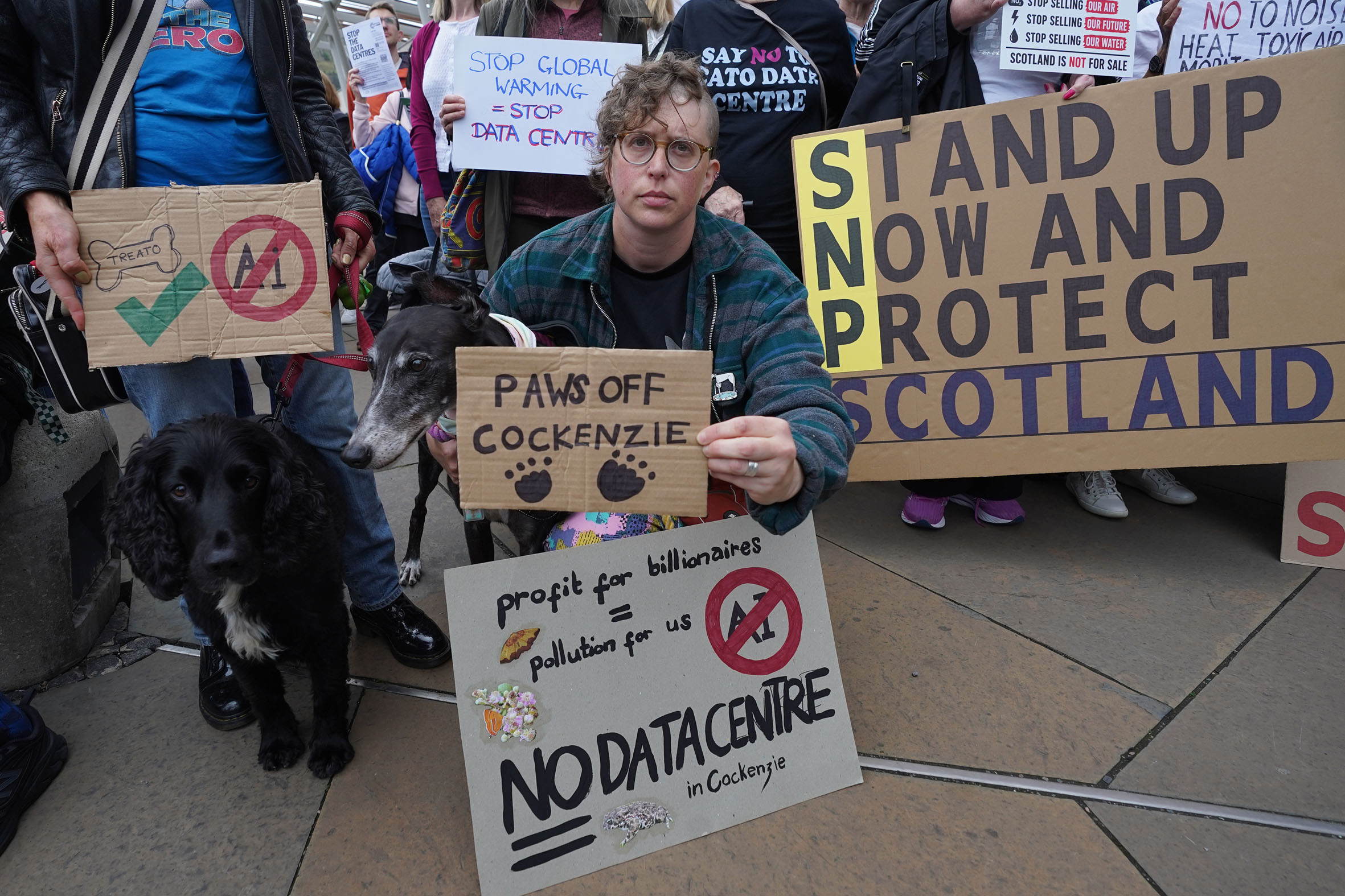 A group of protesters against data centres, holding placards