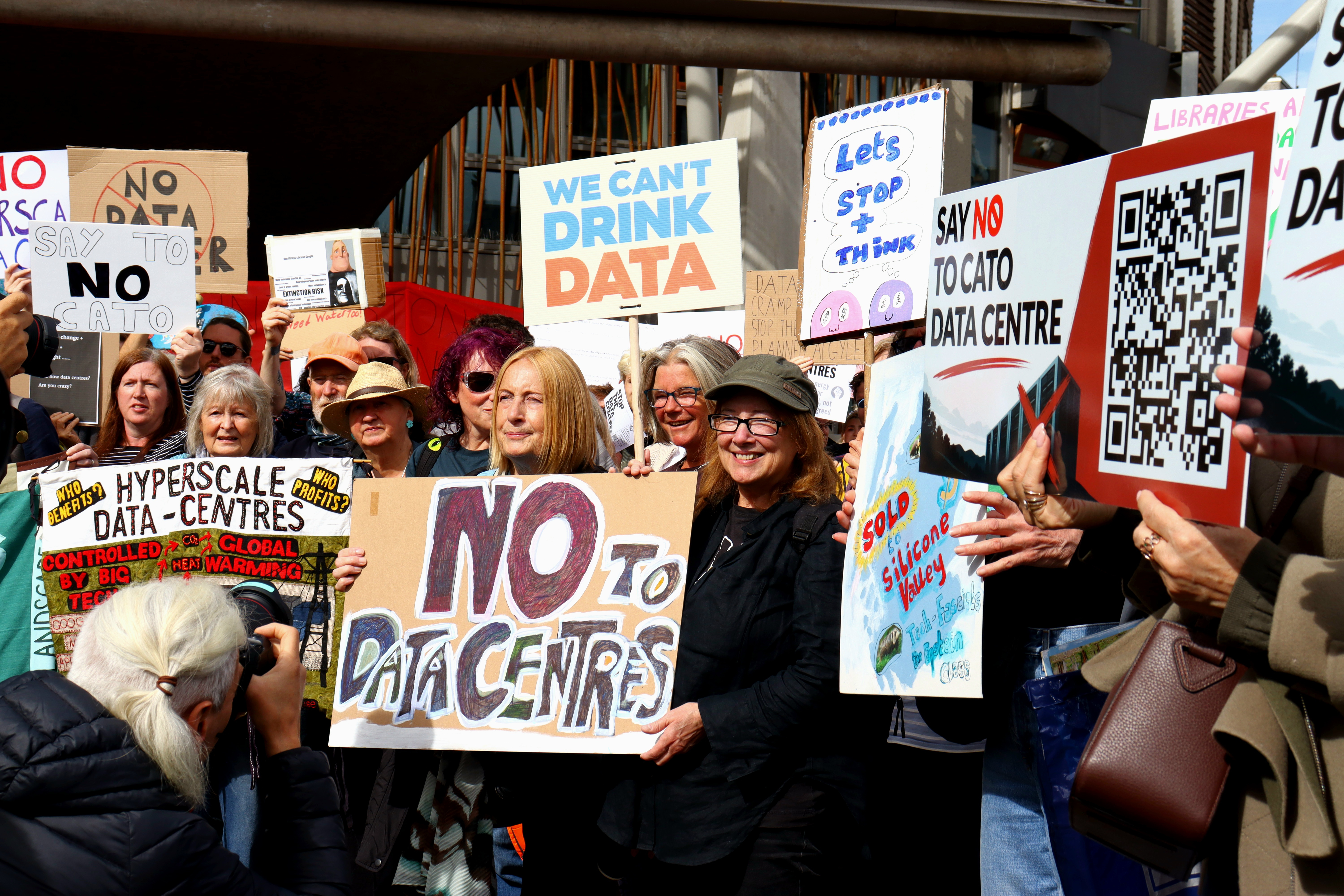 Anti-data centre campaigners at a protest, holding up placards