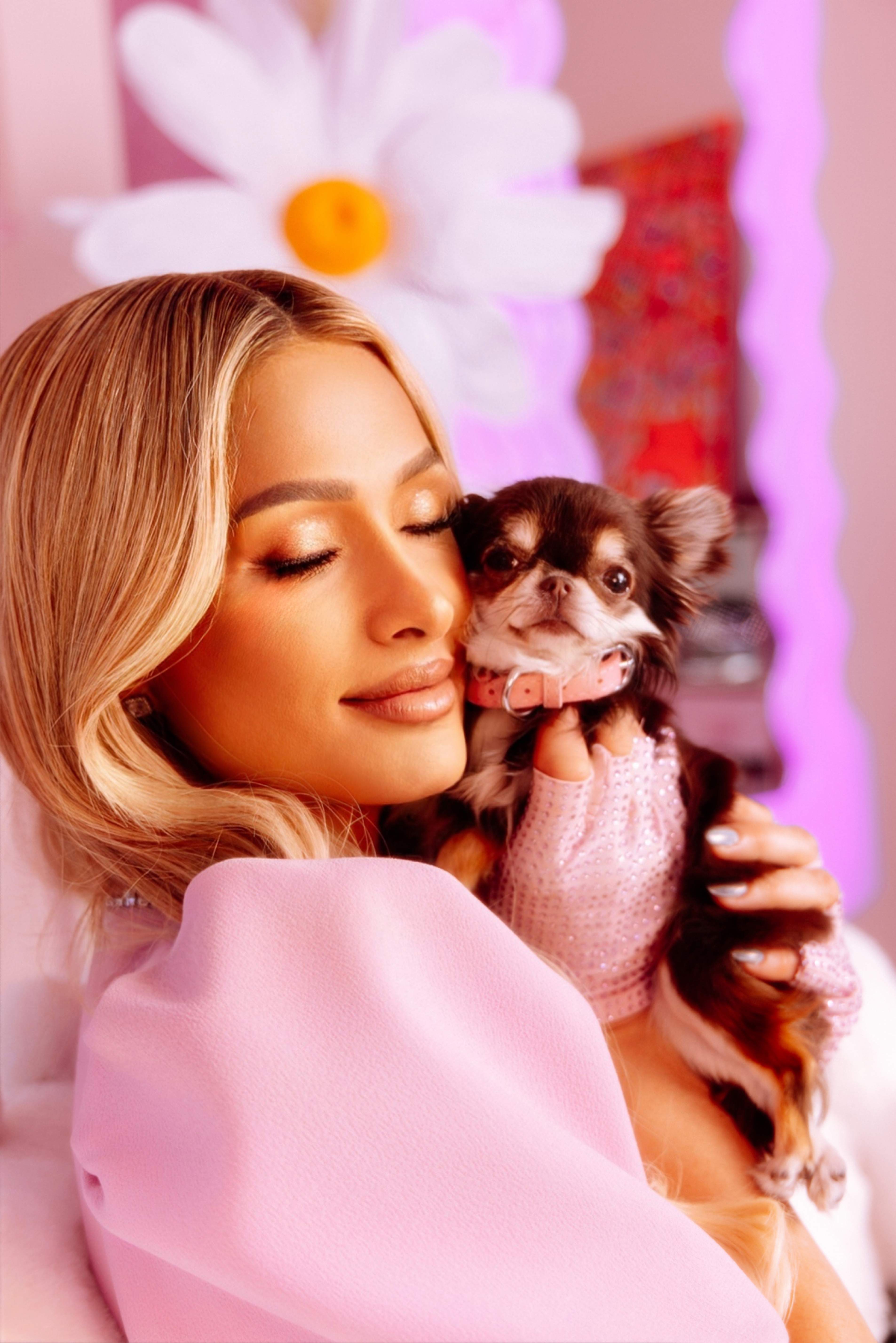 Paris Hilton holding one of her dogs 