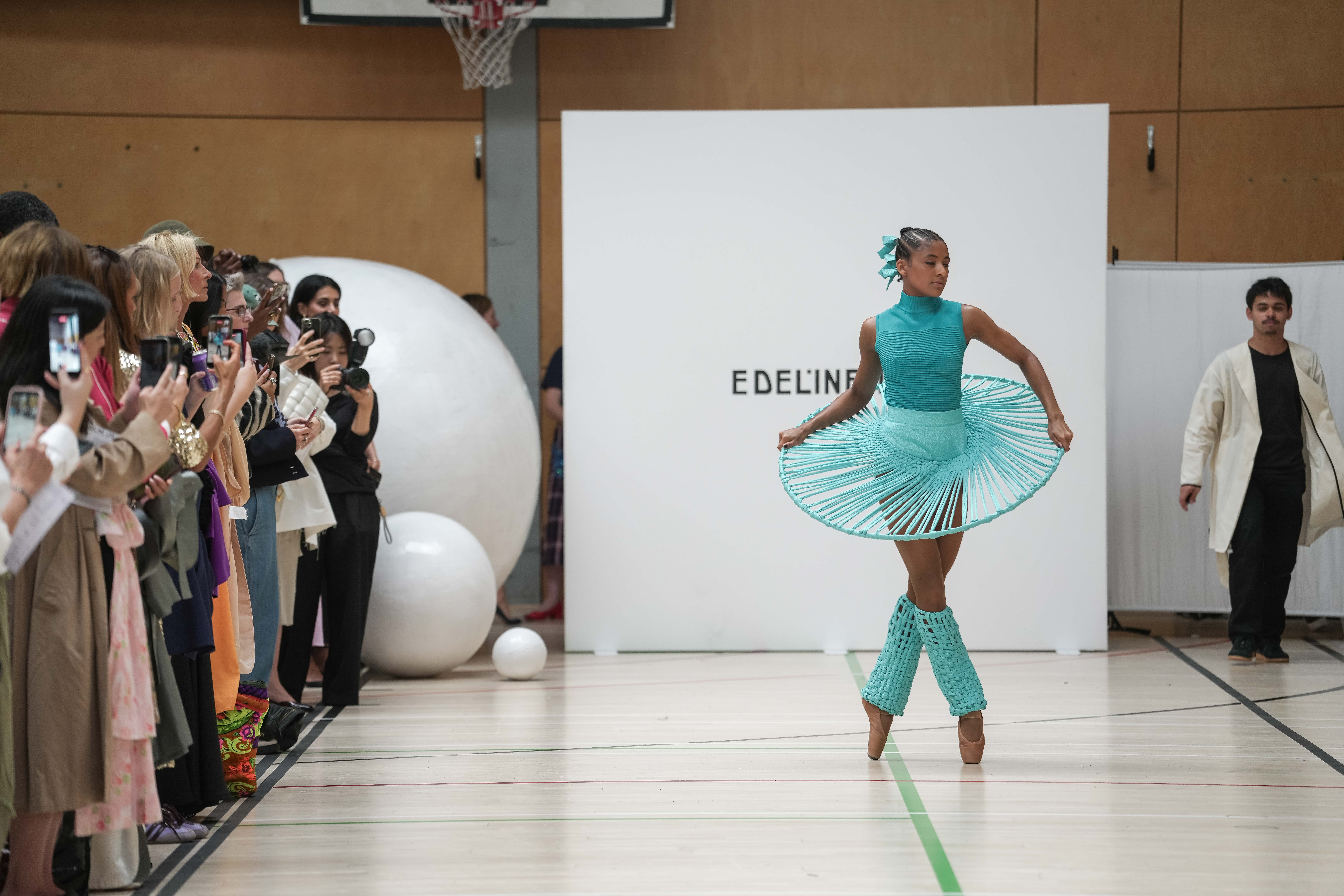 A ballet dancer in a turquoise design on the Edeline Lee runway
