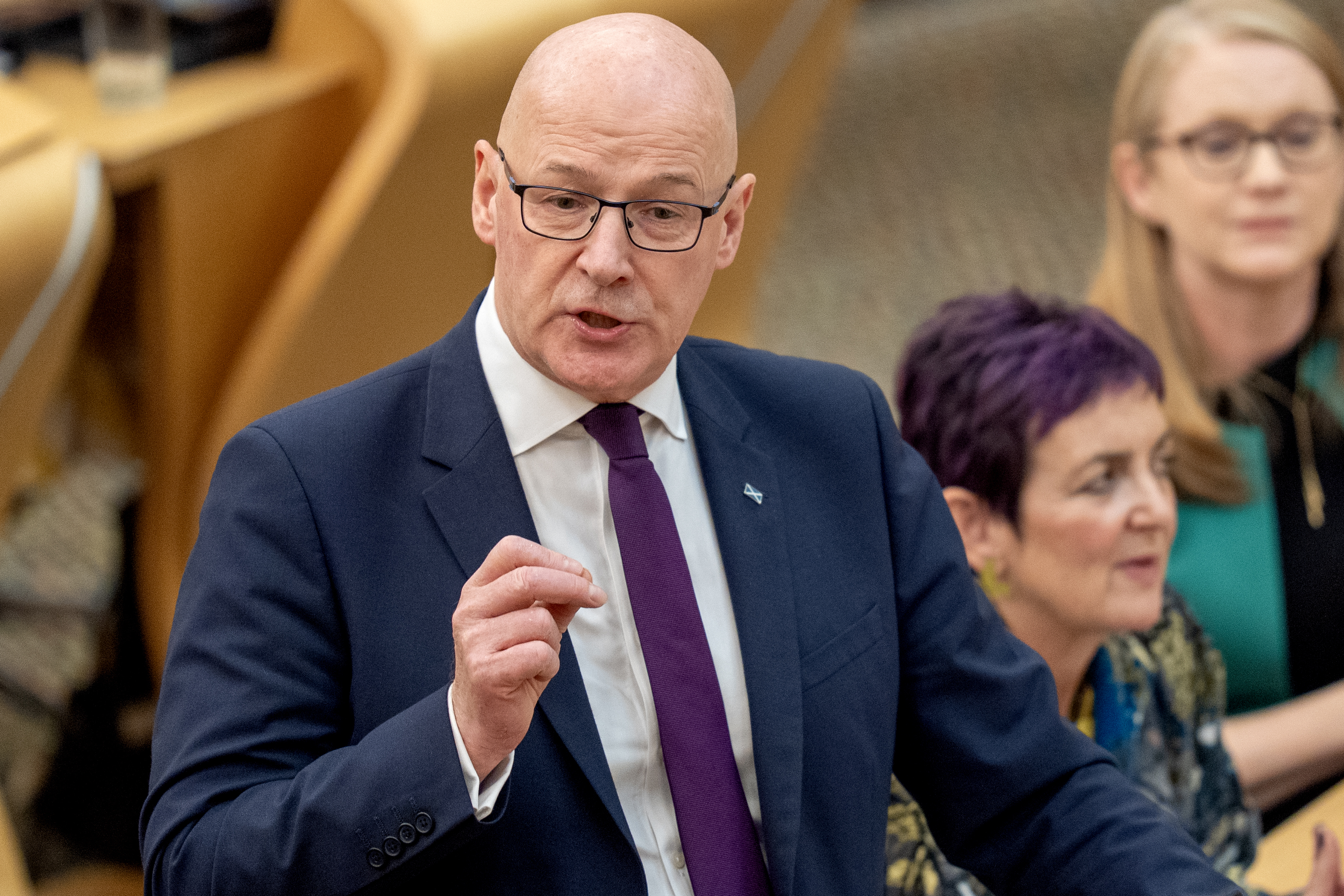 John Swinney standing while speaking in Holyrood
