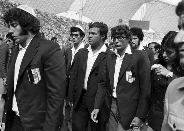Members of Israel’s Olympic team place black ribbons in their pockets after a memorial service mourning their comrades killed in a terror attack and subsequent police shoot-out in 1972
