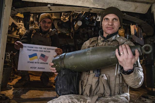 Soldiers of Ukraine’s 5th brigade hold a poster thanking for the US for support