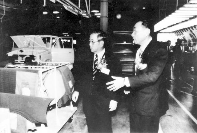 Shoichiro Toyoda, then-chairman of Japan’s Toyota Motor Corporation, left, inspects a production line of light trucks at a Taiwan-Toyota joint venture plant in 1988