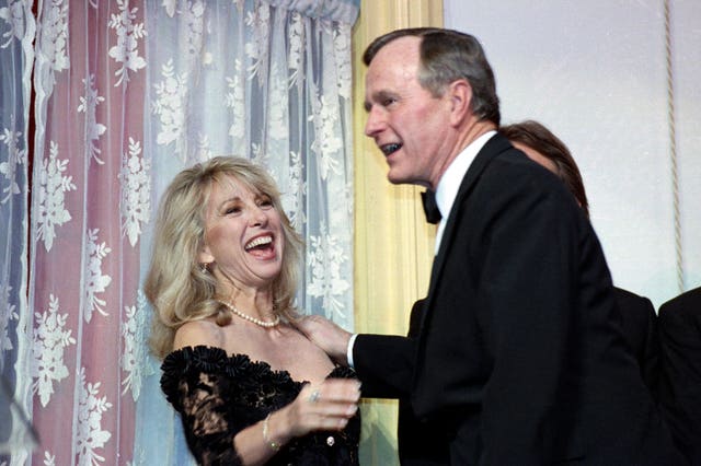 Actress Teri Garr is all smiles after being kissed by President Bush during a fundraising gala for the historic Ford’s Theatre in Washington on March 20 1991