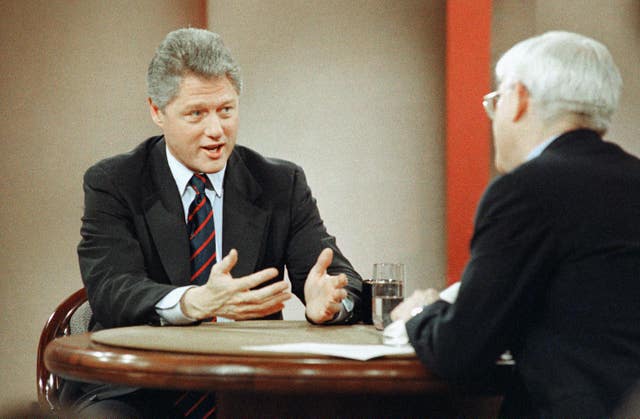 Bill Clinton speaks to Phil Donahue (Stephan Savoia/AP)