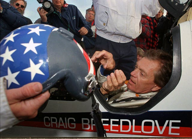 Former land speed record holder Craig Breedlove reaches for his helmet prior to making his first test run in his car Spirit of America on October 23 1996, in the Black Rock Desert near Gerlach, Nevada 
