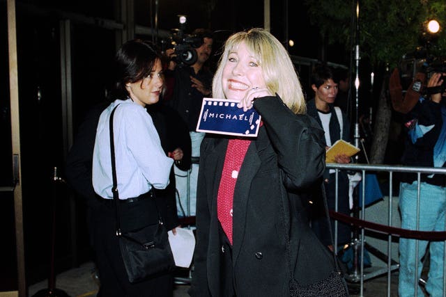 Actress Teri Garr shows off her ticket at the premiere of Michael in 1996 in Beverly Hills, California