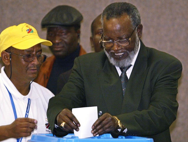 Sam Nujoma casting his vote as an unidentified election worker looks on