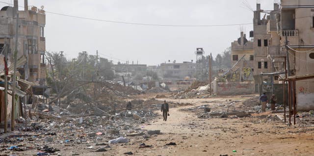 A man walks down a destroyed street in Rafah 