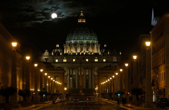 The fool moon is seen above St Peter’s Basilica at the Vatican