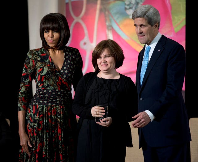 Then-first lady Michelle Obama, left, and then-US secretary of state John Kerry, right, honour Russian human rights activist, journalist Elena Milashina, with an International Women of Courage Award in Washington in 2013