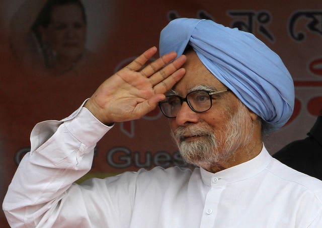 Head and shoulders photo of Manmohan Singh in white shirt and blue turban