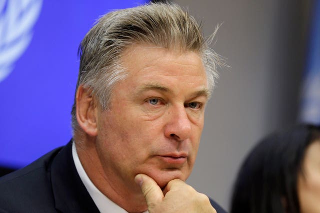 Close up of Alec Baldwin resting his chin on his hand