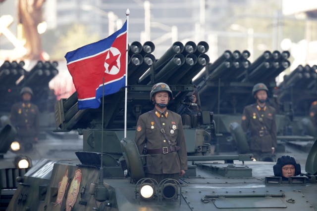 North Korean soldiers stand on armoured vehicles with rocket launchers as they parade in Pyongyang, North Korea, in 2015