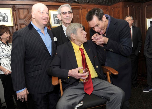 Jeff Ross, from left, Richard Belzer, and Jim Carrey, right, joke with entertainer Jerry Lewis at the Friars Club before his 90th birthday celebration in April 2016 in New York