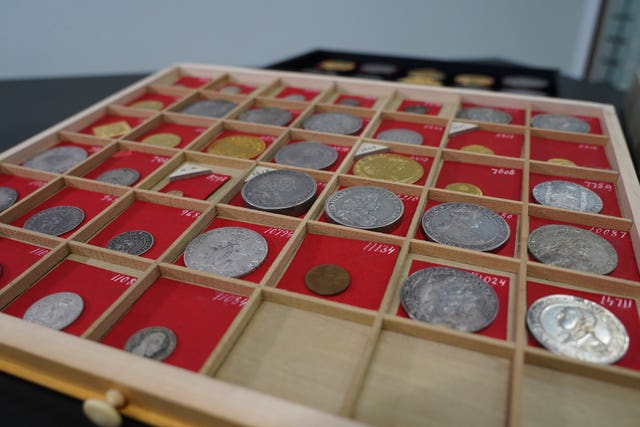 Coins from L.E Bruun’s collection on display on a wooden tray in Zealand, Denmark