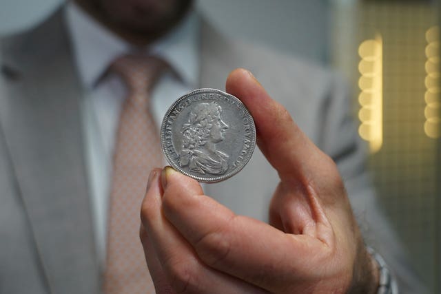 Vicken Yegparian, vice president of numismatics, Stack’s Bowers Galleries, holds a silver Norwegian coin from 1628, part of L E Bruun’s collection, in Zealand, Denmark
