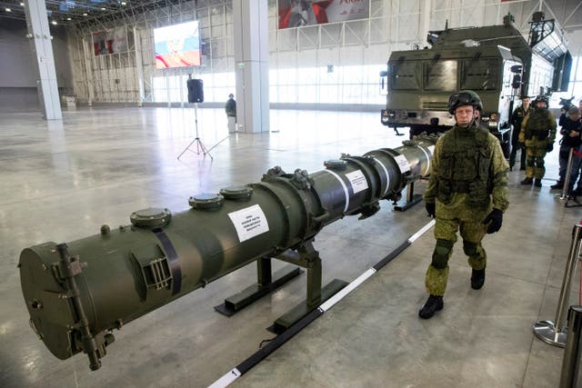 A Russian military officer walks past the 9M729 land-based cruise missile on display in Kubinka, outside Moscow