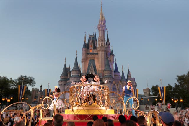 Mickey and Minnie Mouse perform during a parade as they pass by the Cinderella Castle at the Magic Kingdom theme park at Walt Disney World in Lake Buena Vista, Florida