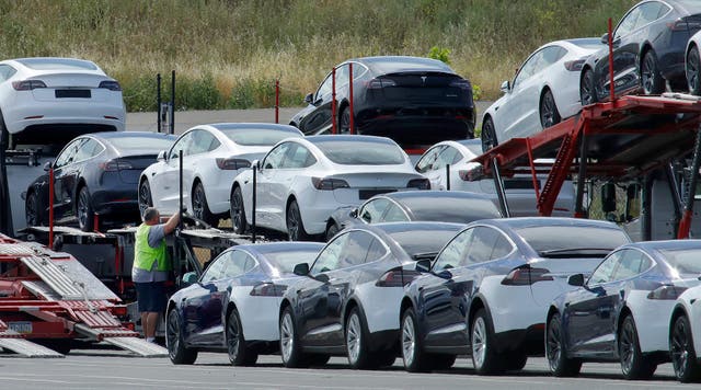 Tesla cars are loaded onto a transporter