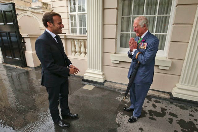 The then-prince of Wales  welcomes French president Emmanuel Macron, left, to Clarence House in London in June 2020