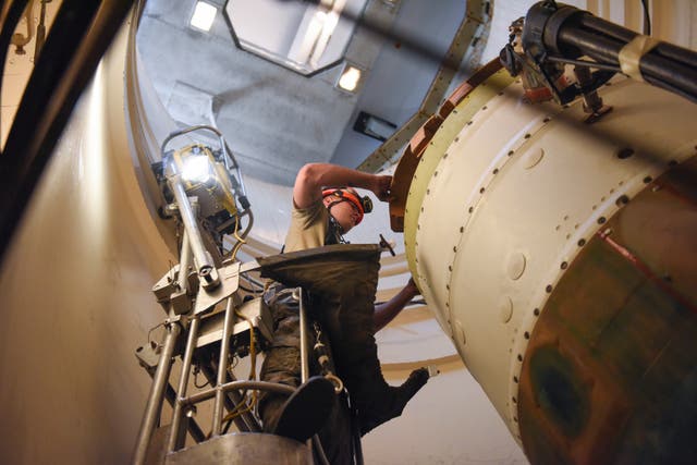 In this image provided by the US Air Force, Airman 1st Class Jackson Ligon, 341st Missile Maintenance Squadron technician, prepares a spacer on an intercontinental ballistic missile during a Simulated Electronic Launch-Minuteman test Sept. 22, 2020, at a launch facility near Malmstrom Air Force Base in Great Falls, Mont