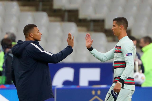 France's Kylian Mbappe high fives Portugal's Cristiano Ronaldo