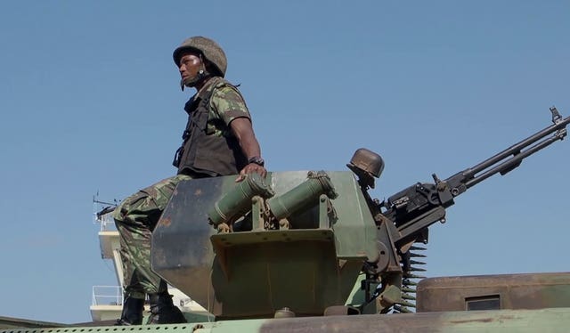 A Mozambican soldier rides on an armoured vehicle in Cabo Delgado province