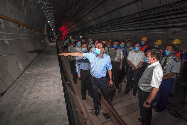 Then-Chinese premier Li Keqiang, front left, wearing a face mask, visits the tunnel of subway line 5 in Zhengzhou city in central China’s Henan province on August 18 2021