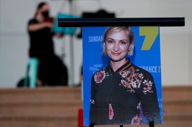 A musician plays a violin behind a photograph of cinematographer Halyna Hutchins during a vigil in her honour in Albuquerque, New Mexico, in October 2021