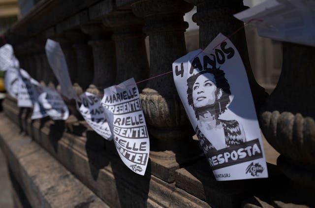 A sign that reads in Portuguese 'four years without answers' displays Marielle Franco's likeness
