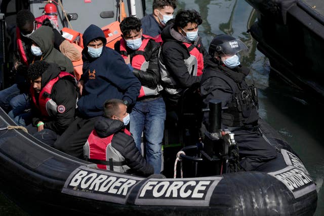 People thought to be migrants, who undertook the crossing from France in small boats and were picked up in the Channel, arrive to be disembarked from a small transfer boat which ferried them from a larger British border force vessel that did not come into the port, in Dover, south east England