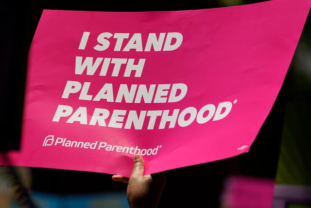 An abortion rights supporter waves a Planned Parenthood placard
