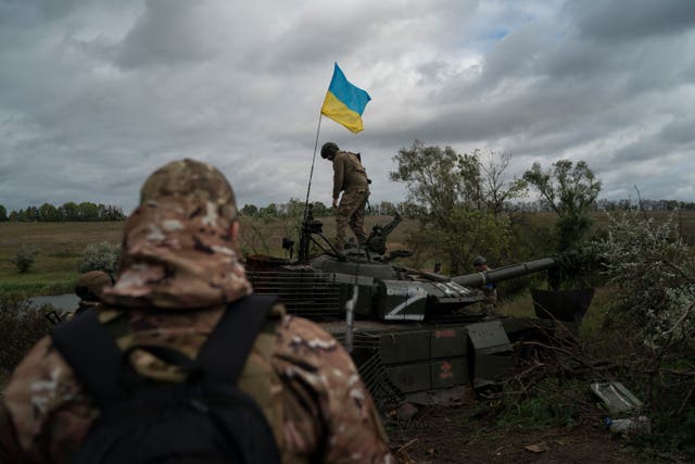 Ukrainian soldier on Russian tank