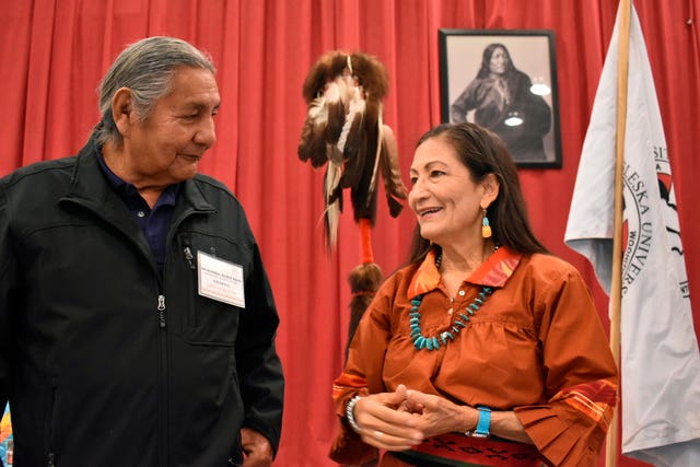 Russell Eagle Bear, with the Rosebud Sioux Reservation Tribal Council, speaks to Deb Haaland during a meeting about Native American boarding schools at Sinte Gleska University Schools