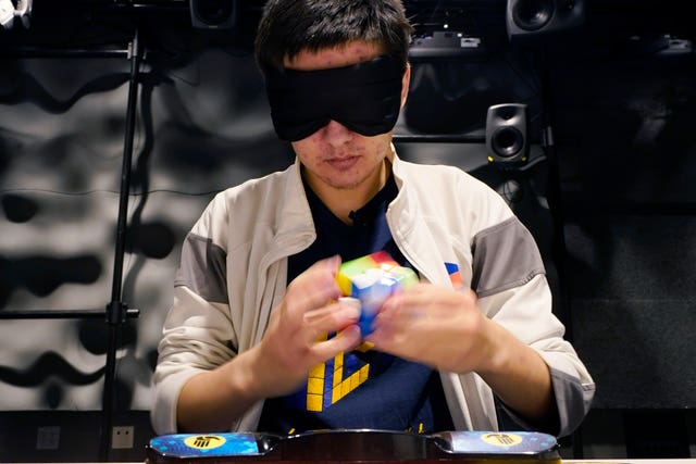 University of Michigan student Stanley Chapel solves a Rubik’s Cube while blindfolded